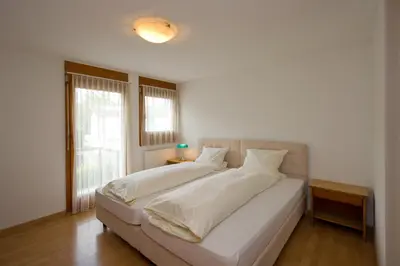 a large white bed in a room with a window at Landgasthof Werdenberg in Werdenberg