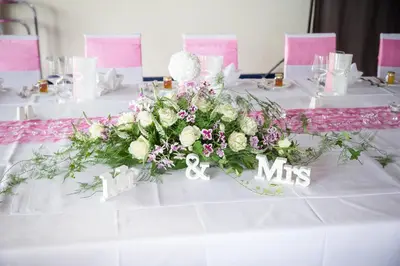 a table with a white table cloth with dishes and glasses at Park - Hotel Inseli in Romanshorn