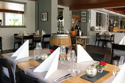 a dining room with a table with glasses and napkins at Hotel Hecht in Rheineck