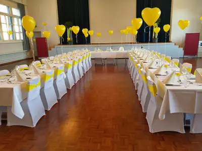 a row of tables with yellow balloons and yellowbons at Hotel Hecht in Rheineck