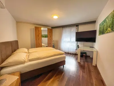 a bedroom with a bed and a flat screen tv at Hotel Hecht in Rheineck