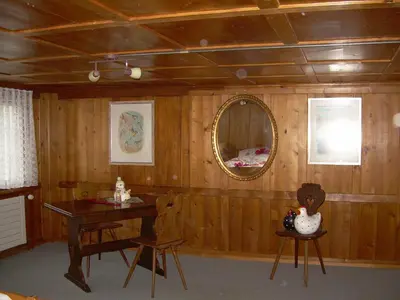 a room with a wooden wall with a table and a mirror at Wohlfühloase für Mensch und Hund in Uzwil