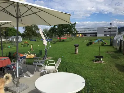 a park with a table and chairs and an umbrella at Wohlfühloase für Mensch und Hund in Uzwil