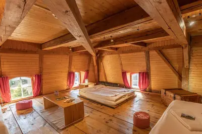 a large room with a bed and a table at Gasthaus Rössli in Mogelsberg