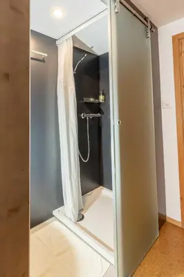 a glass shower door in a bathroom at Gasthaus Rössli in Mogelsberg