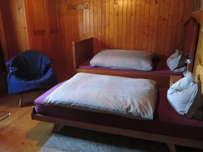 a bedroom with a bed with blue pillows on it at B&B Am Büel in Sevelen