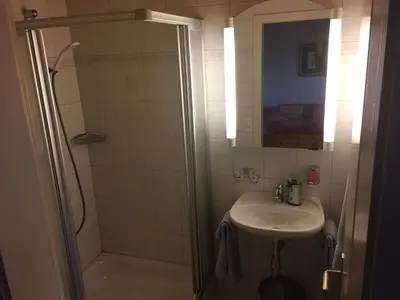 a bathroom with a shower and a sink at Landgasthof Winzelnberg in Egnach