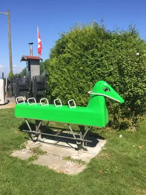 a green bench with a green hat on it at Landgasthof Winzelnberg in Egnach