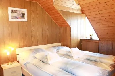 a bedroom with a bed in a wooden room at Restaurant Blume in St. Gallen