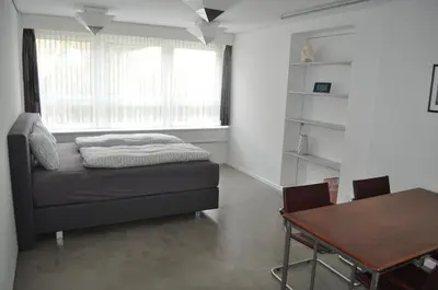 a living room with a couch and a table at Loft AR in Bühler