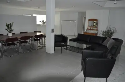 a living room with a couch and a table and chairs at Loft AR in Bühler
