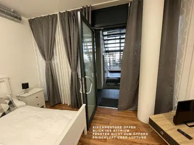 a bedroom with a bed and a glass shower at Berger Zentrum in Berg