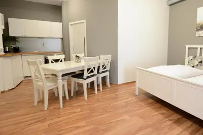 a kitchen and dining room with a white table and chairs at Berger Zentrum in Berg