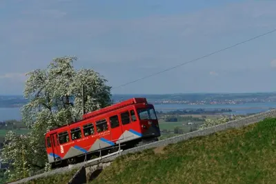 a red train on a track on a hill at Pizzeria-Pension Gambrinus in Walzenhausen