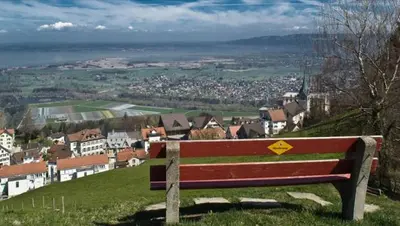 a bench sitting on top of a hill overlooking a town at Pizzeria-Pension Gambrinus in Walzenhausen