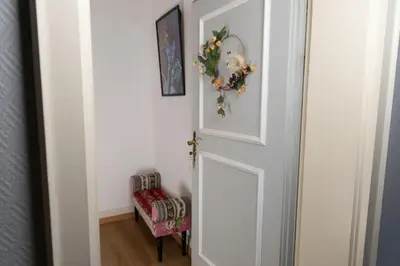 a door with a wreath on it next to a chair at Gasthof Zur Traube in Roggwil