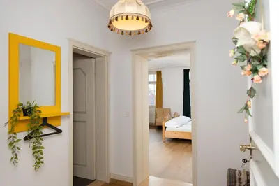 a living room with a hallway with a mirror and a yellow light at Gasthof Zur Traube in Roggwil