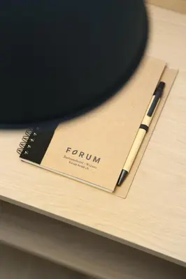 a pen sitting on top of a wooden table at Businesshotel Forum Widnau in Widnau