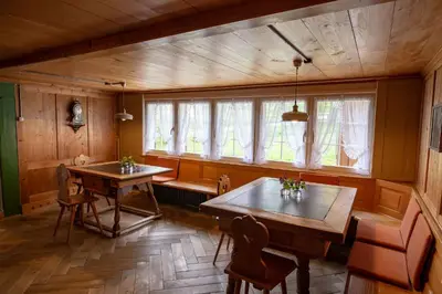 a dining room with two tables and a window at Ferienhotel Idyll Gais in Gais