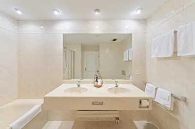 a bathroom with a sink and a large mirror at Hotel Mozart in Rorschach
