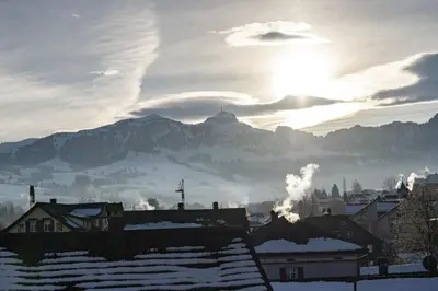 a view of a city with a mountain in the background at Hotel Hecht in Appenzell