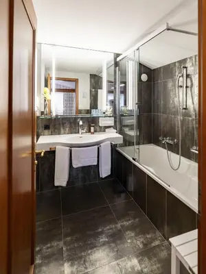 a bathroom with a tub and a sink at Hotel Hecht in Appenzell