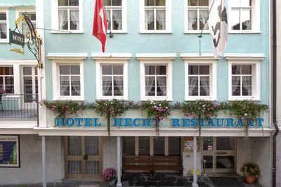 a blue hotel with a sign on the front of it at Hotel Hecht in Appenzell