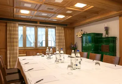 a conference room with a long table with bottles of wine at Hotel Hecht in Appenzell