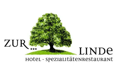 a tree on the grass with the words zerm idea hotel and residentialominium at Hotel & Spezialitätenrestaurant zur Linde in Teufen