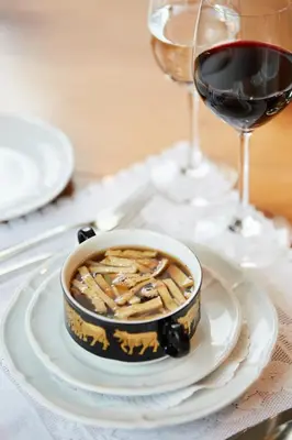 a bowl of food on a table with wine glasses at Hotel & Spezialitätenrestaurant zur Linde in Teufen