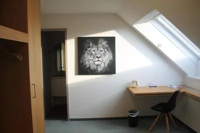 a room with a picture of a lion on the wall at Landgasthof Lowen in Sulgen