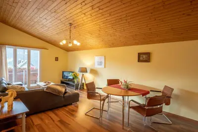 a living room with a couch and a table at Hotel Sonne in Wildhaus