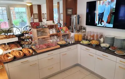 a kitchen with a bunch of food on a counter at Adler Hotel in Appenzell