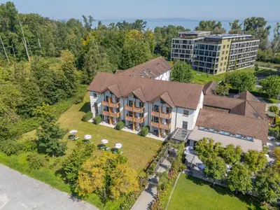 an aerial view of a house with a building at Hotel Restaurant Seegarten in Arbon