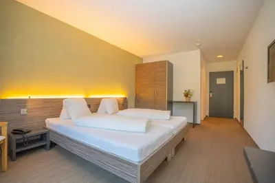 a bedroom with a large bed in a room at Hotel Restaurant Seegarten in Arbon