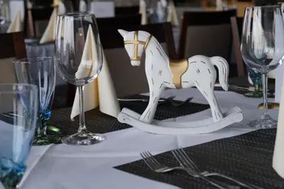 a table topped with a wooden horse on a table with glasses at Bodenseehotel Weisses Rössli in Staad