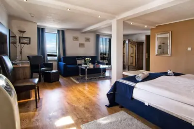 a hotel room with a bed and a living room at Bodenseehotel Weisses Rössli in Staad