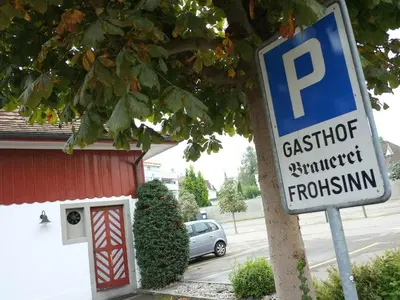 a parking sign in front of a parking lot at Hotel Brauerei Frohsinn in Arbon