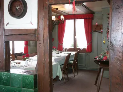 a dining room with a table and some windows at Hotel Garni Sonne in Landschlacht Gemeinde Münsterlingen