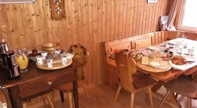 a dining room with a table with food on it at Hof Dietrich in Herisau