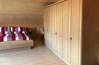 a bedroom with a bed with red pillows at Hof Dietrich in Herisau
