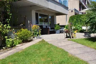 a house with a walkway in front of a yard at Lakelodge Romanshorn in Romanshorn