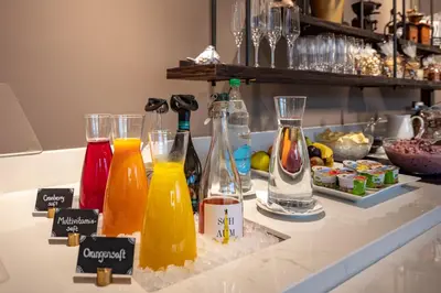 a counter with several bottles of orange juice on it at Hotel Appenzell in Appenzell