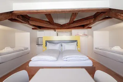 a small room with a bed and two chairs at Linde Heiden Swiss Quality Hotel in Heiden