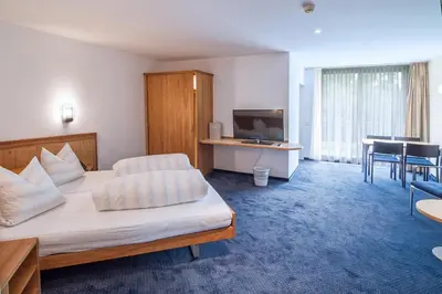 a hotel room with a bed and a television at Hotel Rössli Tufertschwil in Lütisburg