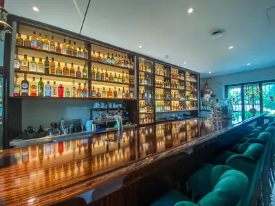 a bar with a lot of bottles of alcohol at Trompeterschlössle Hotel & Residence in Tägerwilen