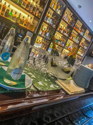 a counter with two empty wine bottles on plates at Trompeterschlössle Hotel & Residence in Tägerwilen