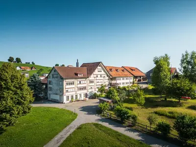 an aerial view of a house in a village at Hotel am Schönenbühl in Speicher