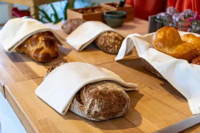 a group of breads and croissants on a table at Hotel am Schönenbühl in Speicher