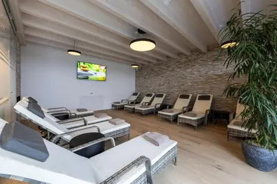 a kitchen with two tables and chairs in a room at Seemöwe Wellnesshotel Swiss Quality in Güttingen